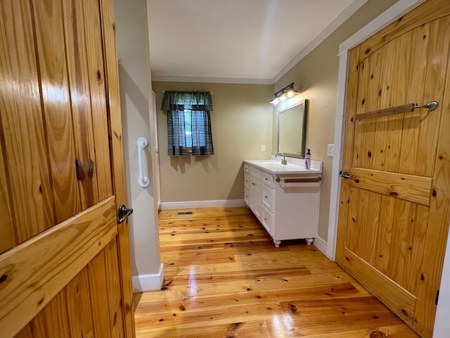 4694 County Road 1718, Holly Pond, AL 35083 - bathroom featuring vanity, hardwood / wood-style flooring, and ornamental molding