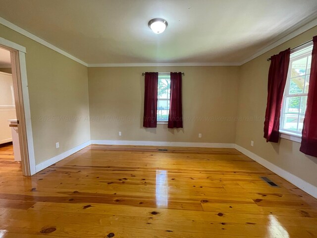 4694 County Road 1718, Holly Pond, AL 35083 - unfurnished room with ornamental molding, healthy amount of natural light, and wood-type flooring