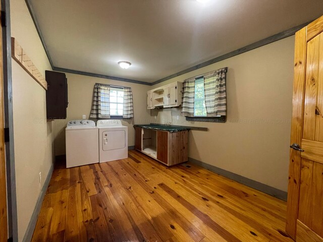 4694 County Road 1718, Holly Pond, AL 35083 - laundry area featuring separate washer and dryer, hardwood / wood-style flooring, and ornamental molding