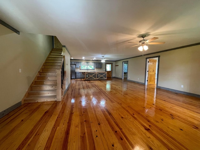 4694 County Road 1718, Holly Pond, AL 35083 - unfurnished living room featuring a ceiling fan, hardwood / wood-style floors, and stairway