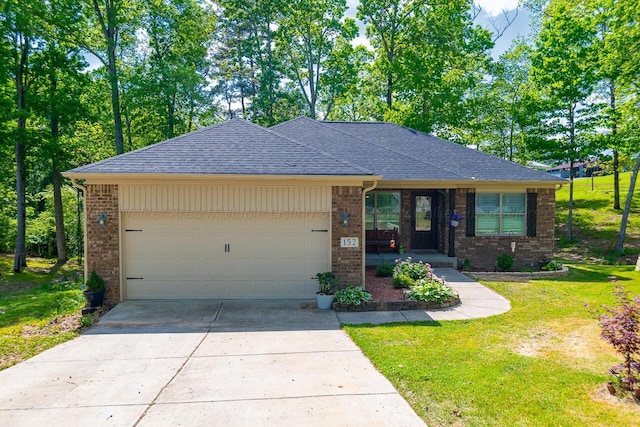 ranch-style home featuring a garage, a front lawn, brick siding, a shingled roof, and concrete driveway