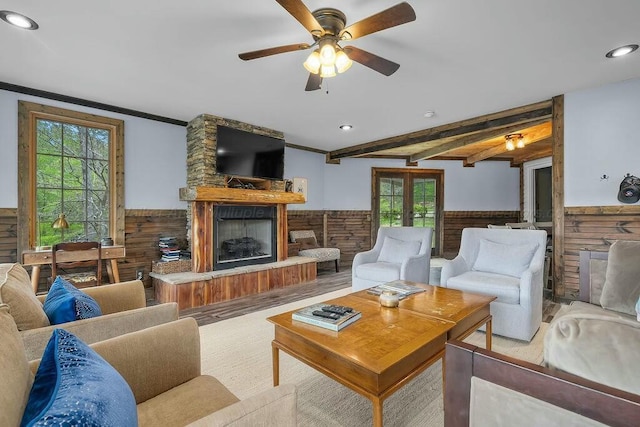 living room with a wainscoted wall, plenty of natural light, recessed lighting, ceiling fan, and a fireplace