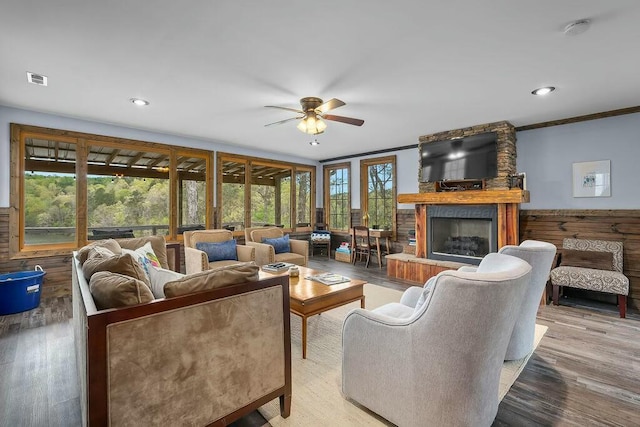 living room featuring a ceiling fan, wood finished floors, a large fireplace, and recessed lighting