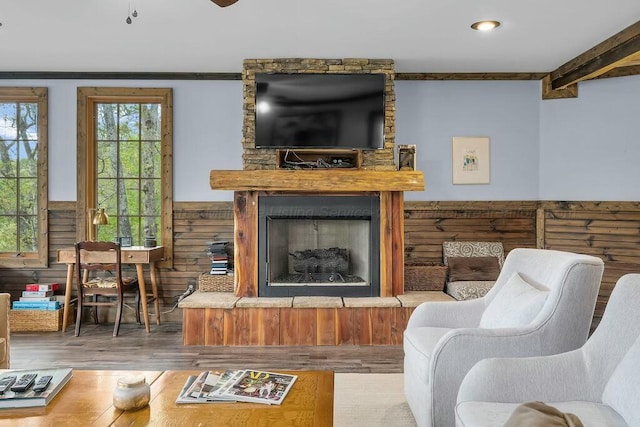 living room with recessed lighting, wood finished floors, and a fireplace