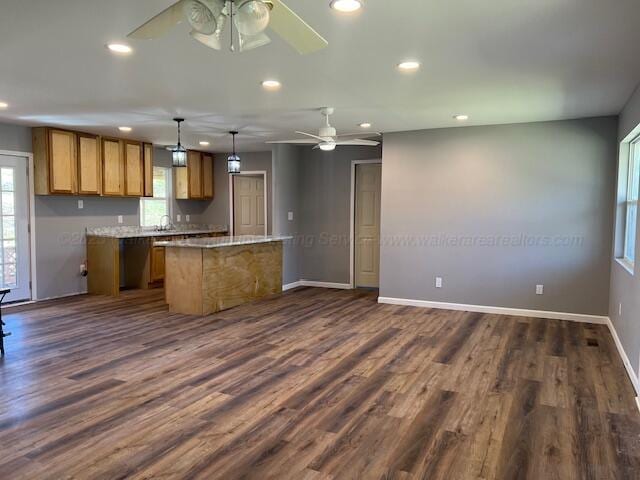 kitchen with dark wood-style floors, ceiling fan, brown cabinets, and recessed lighting