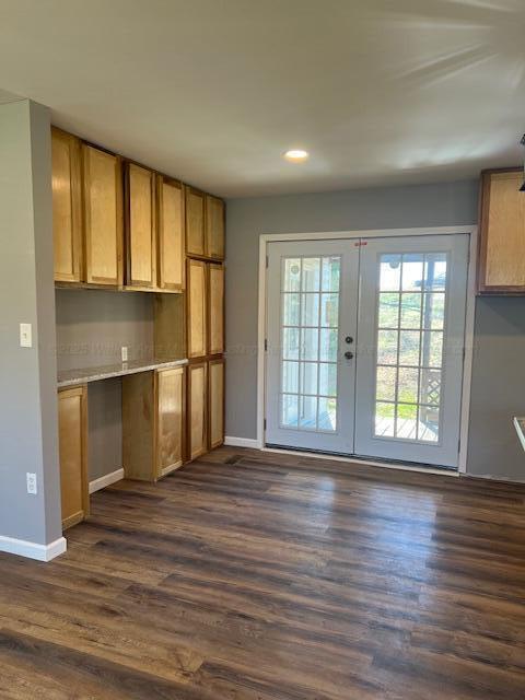 kitchen with baseboards, brown cabinetry, french doors, and dark wood-style flooring