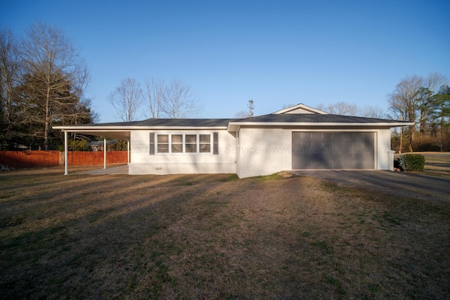 ranch-style home with a garage, a front yard, and a carport