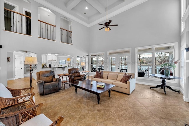 187 S Pointe Dr, Arley, AL 35541 - living area with arched walkways, ceiling fan, a high ceiling, healthy amount of natural light, and baseboards