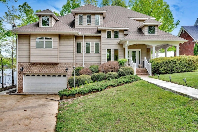 187 S Pointe Dr, Arley, AL 35541 - view of front facade featuring a shingled roof, covered porch, a garage, a front lawn, and concrete driveway