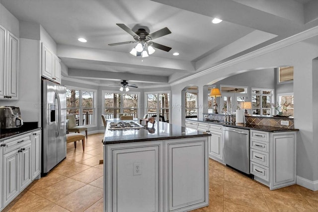 187 S Pointe Dr, Arley, AL 35541 - kitchen with stainless steel appliances, a tray ceiling, ceiling fan, arched walkways, and a kitchen island