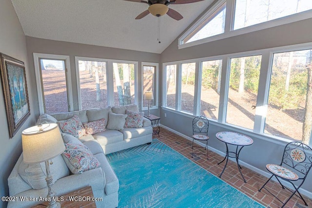 sunroom with plenty of natural light, ceiling fan, and vaulted ceiling