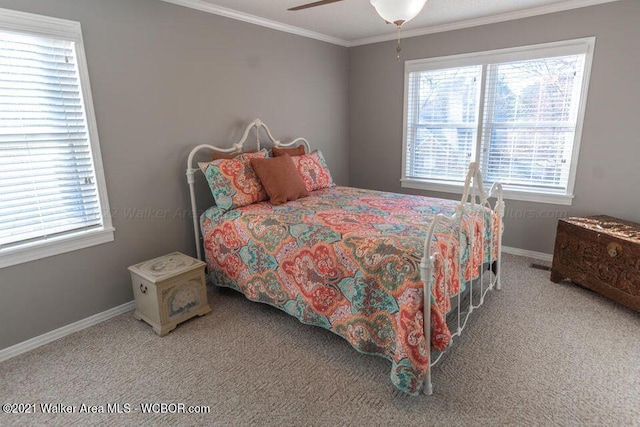 carpeted bedroom with ceiling fan and crown molding