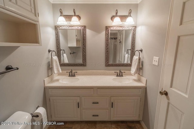 bathroom featuring vanity, toilet, and crown molding