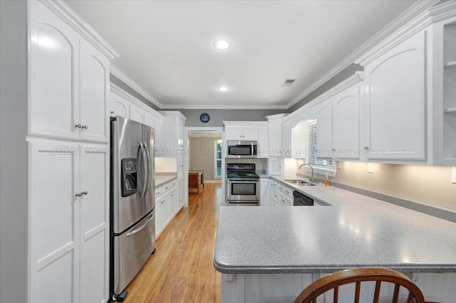 526 Boat Launch Rd, Quinton, AL 35130 - kitchen featuring stainless steel appliances, light wood-type flooring, a peninsula, white cabinetry, and crown molding