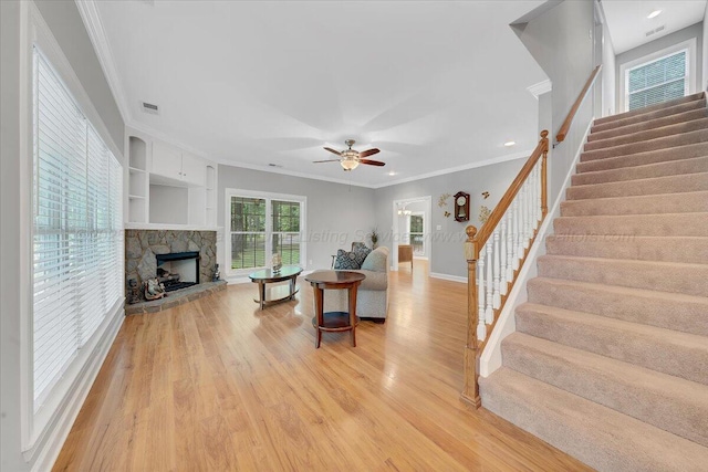 526 Boat Launch Rd, Quinton, AL 35130 - living room featuring stairway, crown molding, light wood finished floors, a fireplace, and ceiling fan