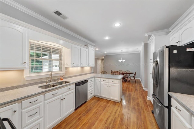 526 Boat Launch Rd, Quinton, AL 35130 - kitchen with appliances with stainless steel finishes, white cabinetry, light wood-style floors, ornamental molding, and a peninsula