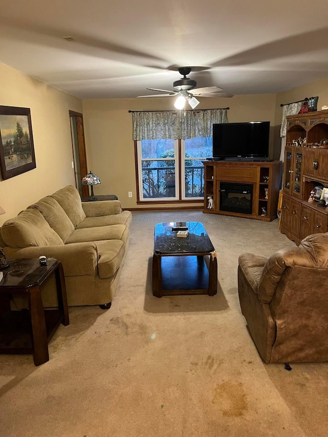 carpeted living room with a ceiling fan