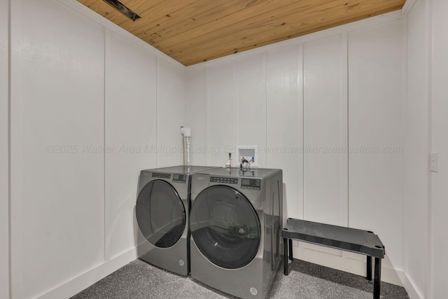 washroom with wooden ceiling, laundry area, a decorative wall, and independent washer and dryer