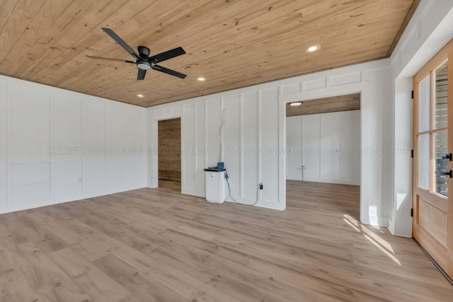 spare room featuring light wood-type flooring, wooden ceiling, a decorative wall, and recessed lighting