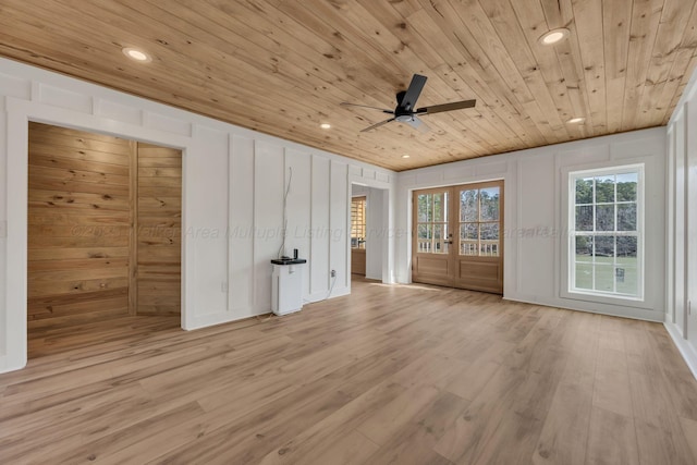 interior space with french doors, recessed lighting, a decorative wall, wood ceiling, and wood finished floors