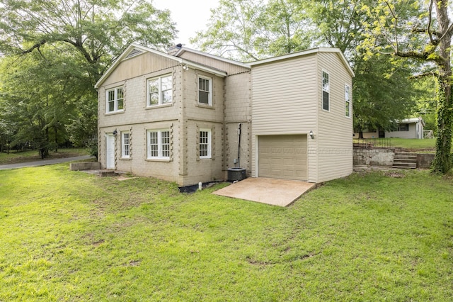 409 W 13th St, Jasper, AL 35501 - back of house featuring a yard, cooling unit, and a garage