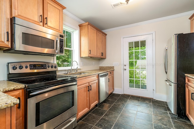 409 W 13th St, Jasper, AL 35501 - kitchen featuring appliances with stainless steel finishes, ornamental molding, baseboards, a sink, and stone tile flooring