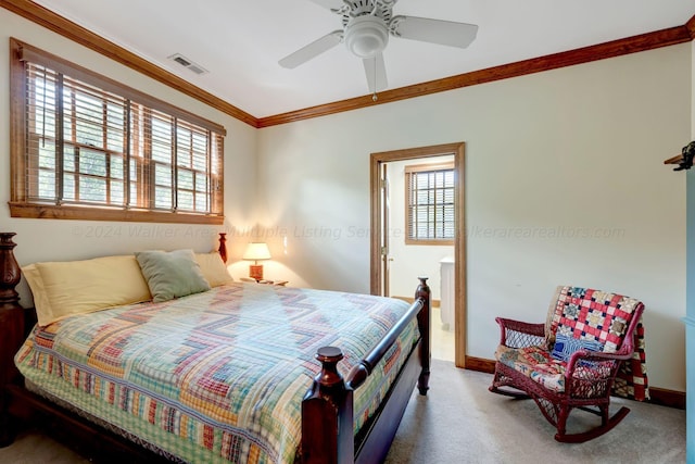 carpeted bedroom with a ceiling fan, crown molding, baseboards, and visible vents