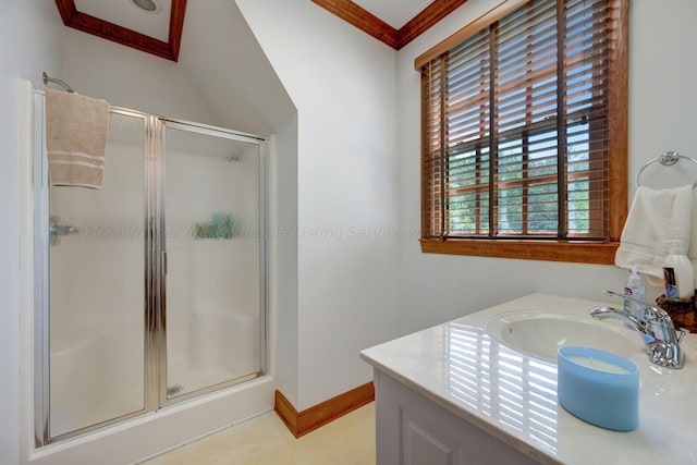 bathroom with vanity, a wealth of natural light, a shower stall, and ornamental molding