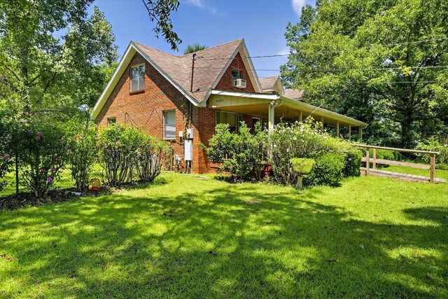 3209 Elm St, Adamsville, AL 35005 - view of home's exterior with a yard, brick siding, and roof with shingles