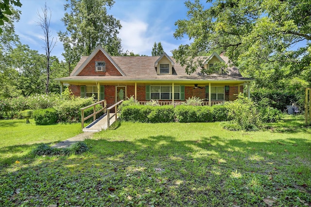 3209 Elm St, Adamsville, AL 35005 - cape cod house featuring a front lawn, brick siding, and a porch