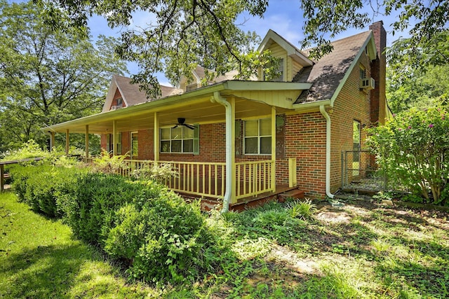 3209 Elm St, Adamsville, AL 35005 - view of side of home featuring brick siding, a porch, a chimney, roof with shingles, and a ceiling fan
