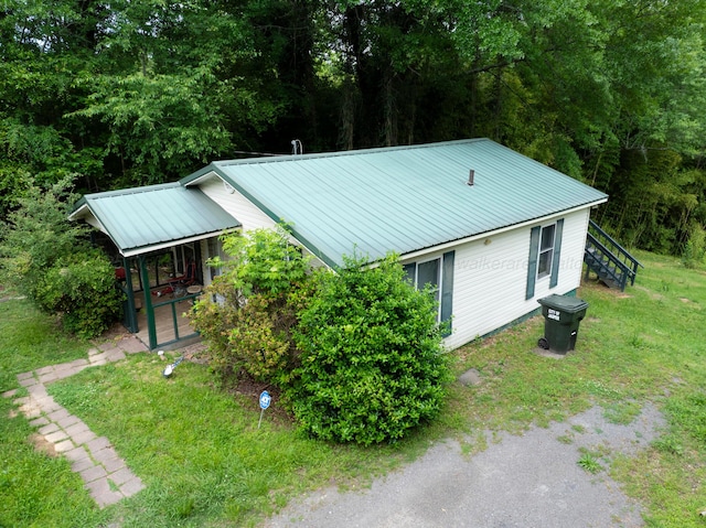 2701 Preston Ave, Jasper, AL 35501 - view of property exterior featuring metal roof, a yard, and stairway
