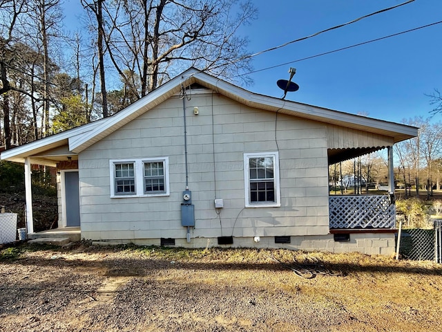 view of property exterior featuring covered porch and crawl space