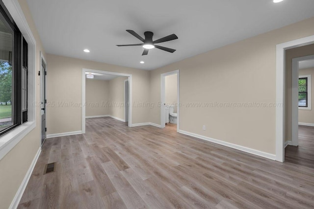 unfurnished room with recessed lighting, wood finished floors, a ceiling fan, and baseboards