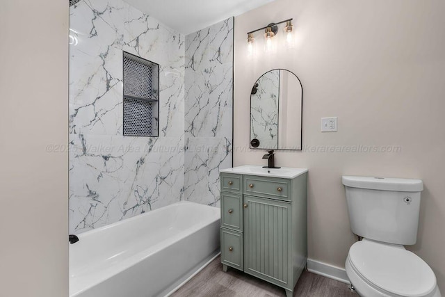 full bathroom with wood finished floors, toilet, and vanity