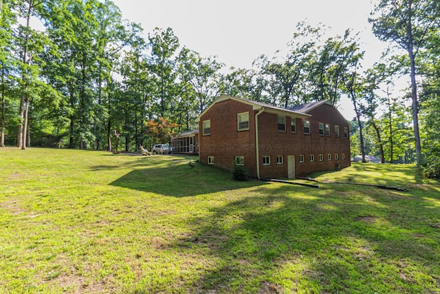 3111 18th Ave, Haleyville, AL 35565 - view of property exterior featuring brick siding and a yard