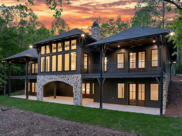 back of property featuring a patio, french doors, and a balcony