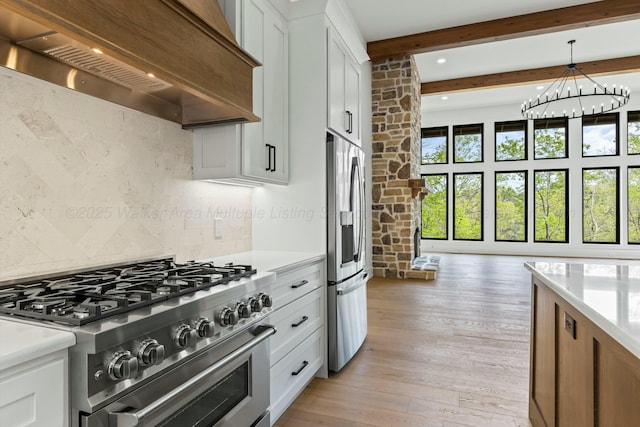 kitchen featuring light countertops, beamed ceiling, stainless steel appliances, and custom range hood