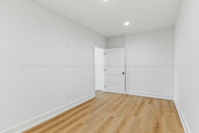 spare room with recessed lighting, baseboards, and light wood-style floors