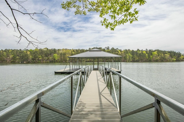 dock area featuring a water view, a gazebo, and a forest view