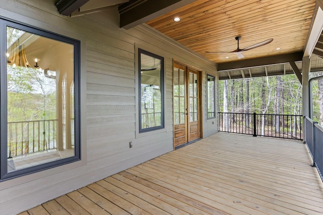 wooden deck with ceiling fan and french doors