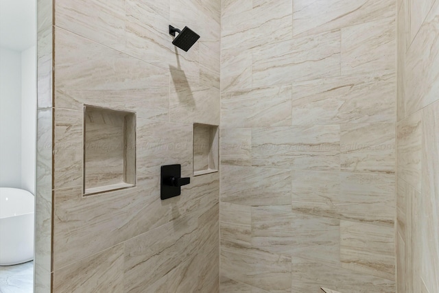 bathroom with a freestanding bath and a tile shower