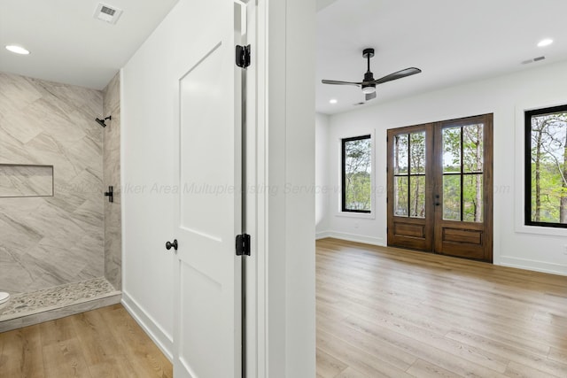 entrance foyer featuring a wealth of natural light, baseboards, visible vents, and light wood-style floors