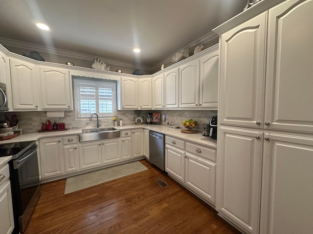 kitchen featuring electric range, dishwasher, a sink, dark wood-style flooring, and tasteful backsplash