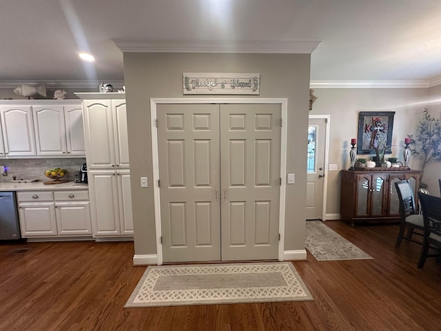 entryway featuring crown molding, dark wood-style flooring, and baseboards