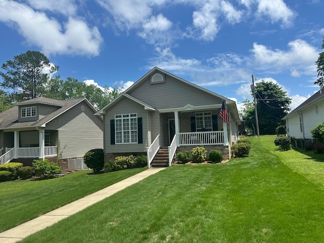 view of front of property featuring a porch, a front lawn, and cooling unit