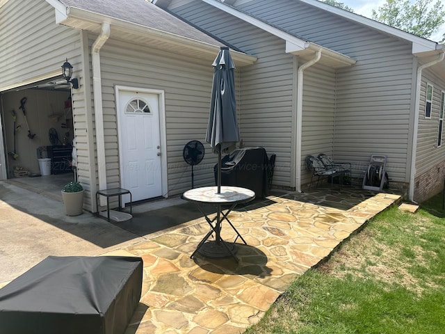 back of house with a patio and roof with shingles
