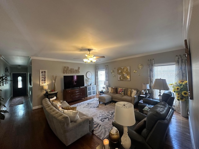 living area with wood finished floors, a ceiling fan, crown molding, and baseboards
