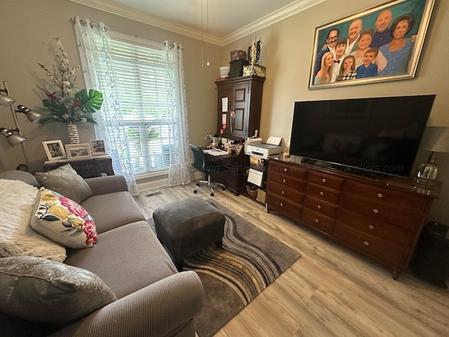 living area with light wood-style floors, ornamental molding, and a desk
