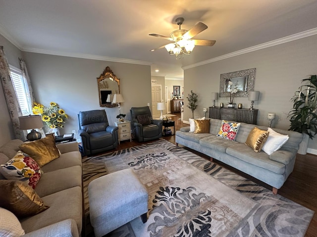 living area with wood finished floors, a ceiling fan, crown molding, and baseboards